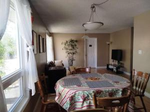 a dining room with a table and a window at Jenny Guest House in Yellowknife