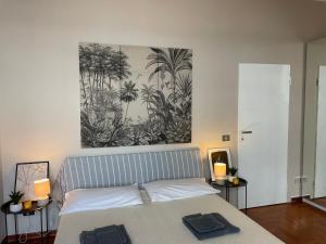 a bedroom with a bed with a painting on the wall at Casa Della Baia With a beautiful view in Varazze +54 photos