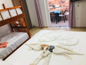 a dog laying on two beds in a room at Apartments panoramic Ana in Sarandë