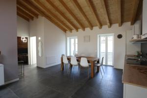 a kitchen and dining room with a table and chairs at Casa BEA 4 in Castione della Presolana