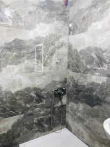 a bathroom with a marble shower with a sink at Apartments panoramic Ana in Sarandë