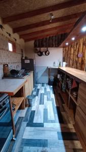 a kitchen with a blue and white tile floor at Aguas Sagradas de Panqui in Curarrehue