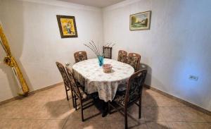 a dining room table with chairs and a white table cloth at The view house Lučano in Vidović