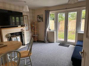 a living room with a table and a fireplace at 3 Bed Entire House - Runcorn in Runcorn