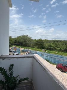 a balcony with a view of a parking lot at Nirvana Stays - 2BHK - Luxury - Peace - Comfort in Haidar Sāhibgūda