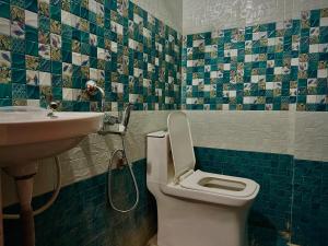 a bathroom with a toilet and a sink at Nirvana Stays - 2BHK - Luxury - Peace - Comfort in Haidar Sāhibgūda +16 photos