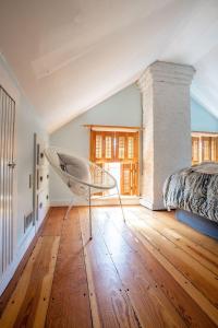 a bedroom with a chair and a bed in a room at The Wildflower House Yellow Springs AND Pet Friendly 