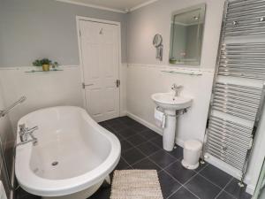 a bathroom with a sink and a tub and a toilet at Rose Briar Cottage in Morpeth +23 photos
