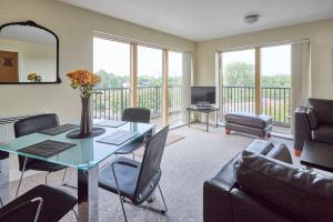 a living room with a table and chairs and a couch at Host & Stay - Newport House Apartment in Worcester