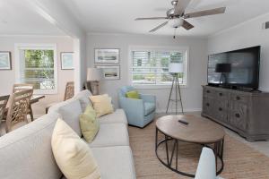a living room with a couch and a tv at 1700 Bruce Drive in Saint Simons Island