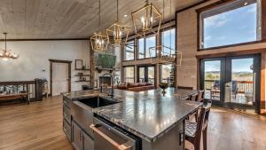 a kitchen with a large island in a room with windows at Sunrise Ridge in Mineral Bluff