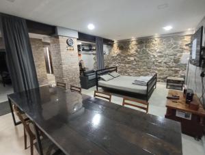 a living room with a table and a bed at 46 Loft apartment with king-size bed in Chernihiv