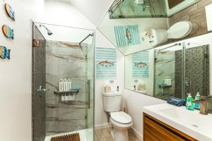 a bathroom with a shower and a toilet and a sink at Pet-Friendly Studio 6 Mi to Jupiter Beach Park! in Jupiter +15 photos