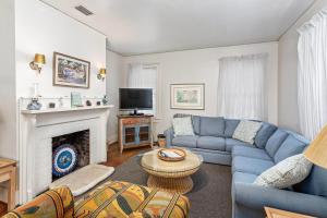 a living room with a blue couch and a fireplace at 609 May Joe in Saint Simons Island