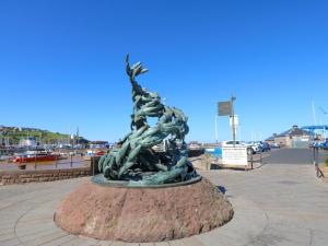 a statue of two people standing on a mound at Lowther Penthouse in Whitehaven