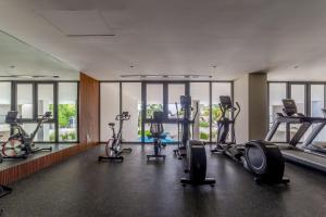 a gym with several treadmills and elliptical machines at Estudio con Terraza en Zantamar in Cruz de Huanacaxtle