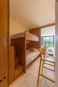 a bedroom with a bunk bed and a desk at Estudio con Terraza en Zantamar in Cruz de Huanacaxtle +10 photos