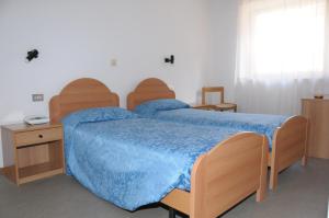 Postel nebo postele na pokoji v ubytování Albergo Vecellio