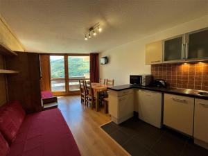 a kitchen and dining room with a table and chairs at Appartement confort pour 5 aux Menuires - Animaux admis - FR-1-452-41 in Les Menuires