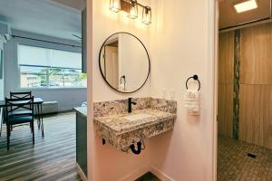 a bathroom with a sink and a mirror on the wall at Unit 4 Waena Inn Newly Renovated Maui Private Suite in Wailuku