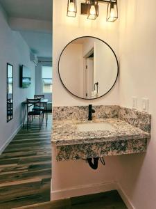 a bathroom with a sink and a mirror on the wall at Unit 4 Waena Inn Newly Renovated Maui Private Suite in Wailuku