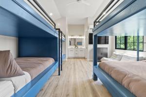 two beds in a room with blue walls at Its about time, for adventure in Hurricane +41 photos