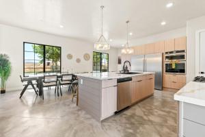 a kitchen and dining room with a table and chairs at Its about time, for adventure in Hurricane