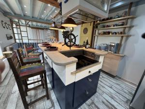 a kitchen with a counter and some chairs in it at Riva Bella Marine in Ouistreham