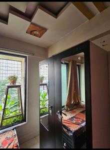 a room with a mirror and a bed in it at Ac Private Room At Ovale Naka thane West in Thane +5 photos