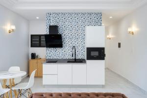 a kitchen with a sink and a counter top at CHROME Résidences Fidjrossè PLAGE in Cotonou