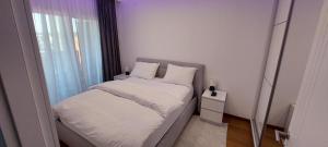 Ένα ή περισσότερα κρεβάτια σε δωμάτιο στο Extra Apartman Palata