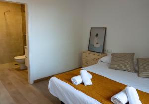 a bedroom with a bed with towels on it at Casa Vella de Casa Torrent in Canet de Mar