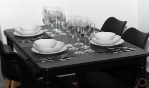 a black table with wine glasses and plates and silverware at FLATS FAMILY APARTAMENTO DE 3 HABITACIONEs in Valencia +46 photos