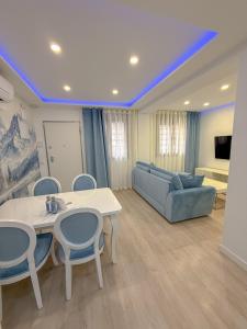 マドリードにあるCharming Madrid Apartment 6 paradas metro El Retiroのテーブルと椅子とソファのあるリビングルーム +5枚の写真