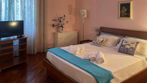 a bedroom with a large bed with a tv on it at VistaVittoria Livorno in Livorno