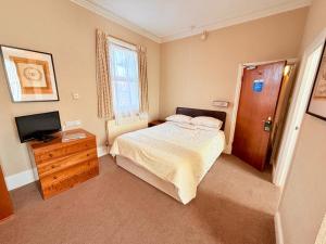 a bedroom with a bed and a television in it at Hylands Hotel Double Room with Private Bathroom & Free Parking in Nottingham