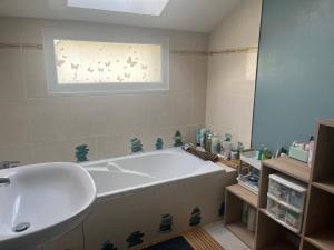 a bathroom with a large tub and a sink at Maison familiale entre Paris et Dysneland in Montreuil