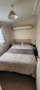 a bedroom with a large bed in a room at Poppy Caravan in Leysdown-on-Sea +26 photos