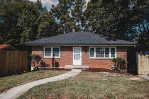 a red brick house with a white door at Cozy midtown 3 bedroom 1 bath in Danville