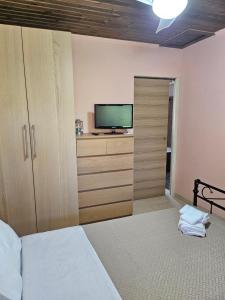 a bedroom with a bed and a flat screen tv at Casa del Mar in Gialtra