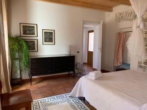 a bedroom with a bed and a dresser in it at B&B Casa Vitale in Villasalto