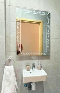 a bathroom with a sink and a mirror at Large 2BR Apartment Near Agadir Medina in Agadir +3 photos