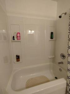 a white bath tub in a bathroom at Jenny Guest House in Yellowknife