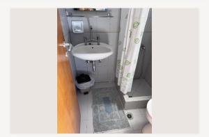 a small bathroom with a sink and a toilet at Ευάγγελος Πολίτης in Pisses +9 photos