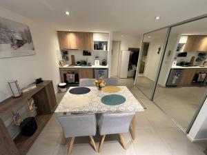 a kitchen with a table and chairs in a room at Austral Apartamentos in Ushuaia