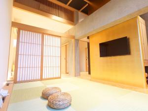 a living room with a flat screen tv on a wall at Dainichiji no Yado Kyoto Kisshoin - Vacation STAY 84550v in Kyoto