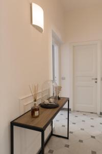 a room with a table in a room with a door at Via Chiodo Luxury Apartment in La Spezia