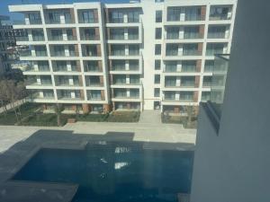 a swimming pool in front of a large apartment building at Sea breeze Park residens 2 in Baku