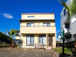 a building with a palm tree in front of it at Genki na yado Asahi - Vacation STAY 62934v in Asahi
