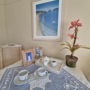 a table with cups and saucers on a table at South Quay no 6 in Knysna